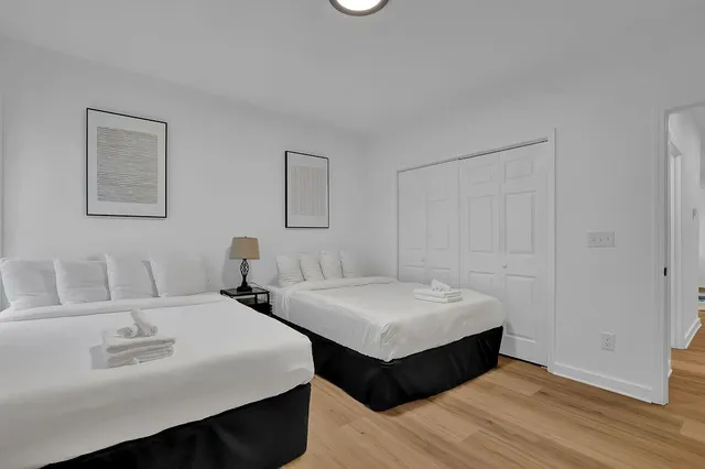 a spacious bedroom with two beds and a table