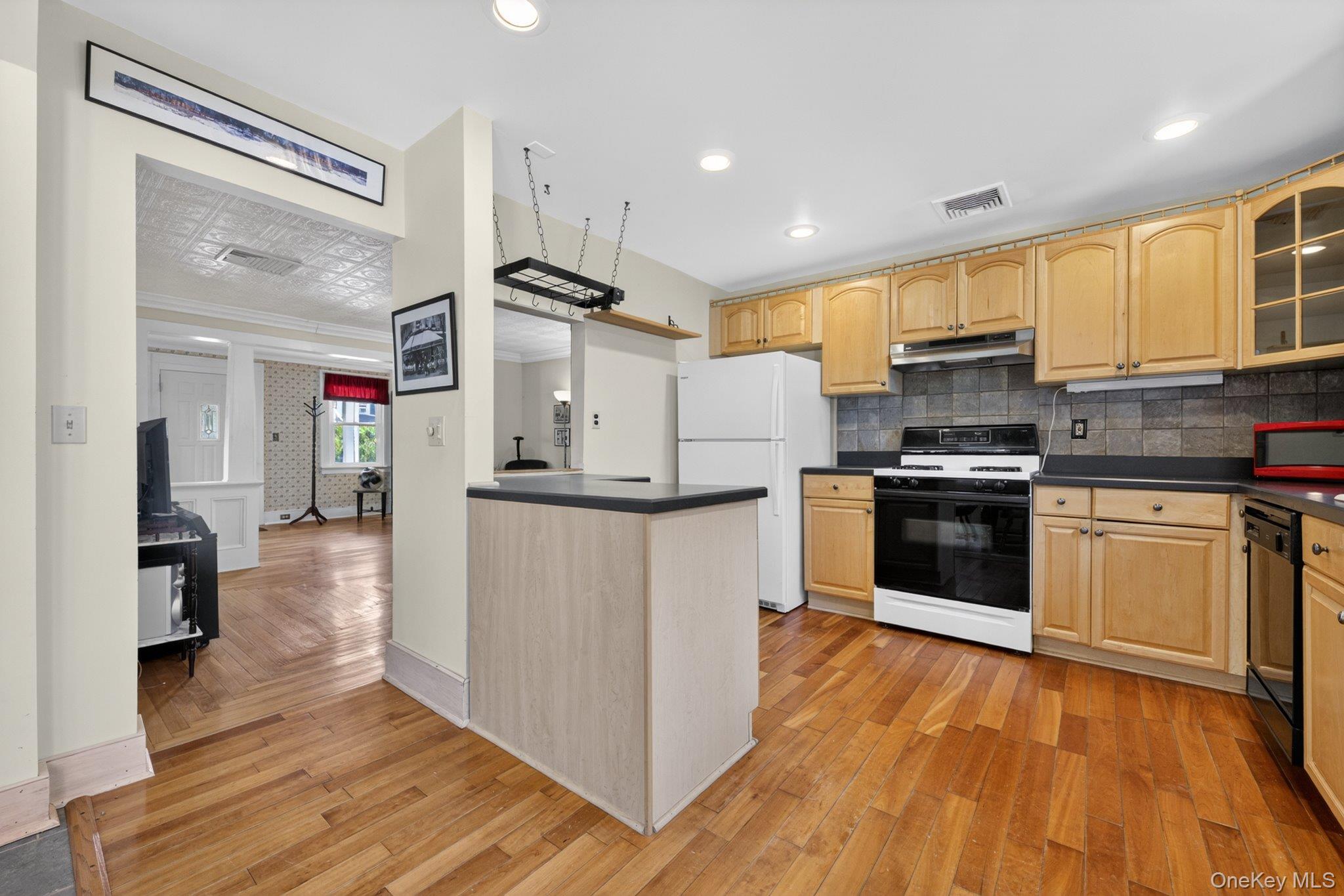250 Rombout Avenue Beacon, NY 12508 - Photo 10 of 33 a kitchen with stainless steel appliances kitchen island granite countertop a refrigerator and a stove top oven