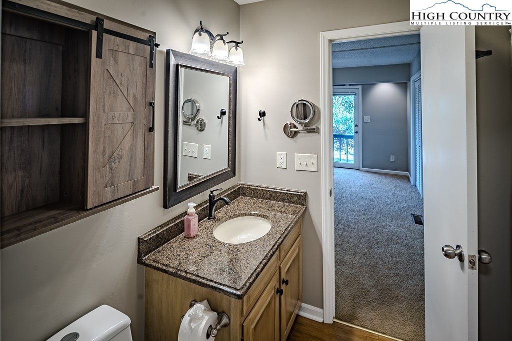 290 Cobble Creek Lane Boone, NC 28607 - Photo 20 of 33 a bathroom with a granite countertop sink a mirror and shower