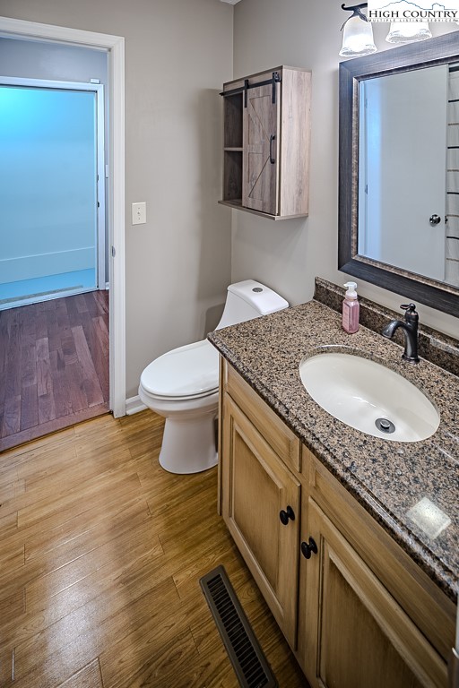 290 Cobble Creek Lane Boone, NC 28607 - Photo 21 of 33 a bathroom with a granite countertop sink a toilet and mirror