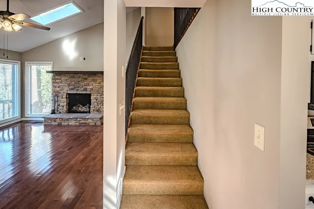 a view of staircase with railing and a window