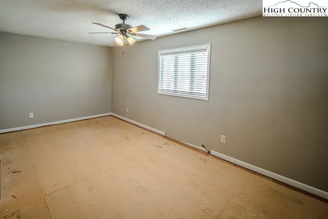 an empty room with windows and closet