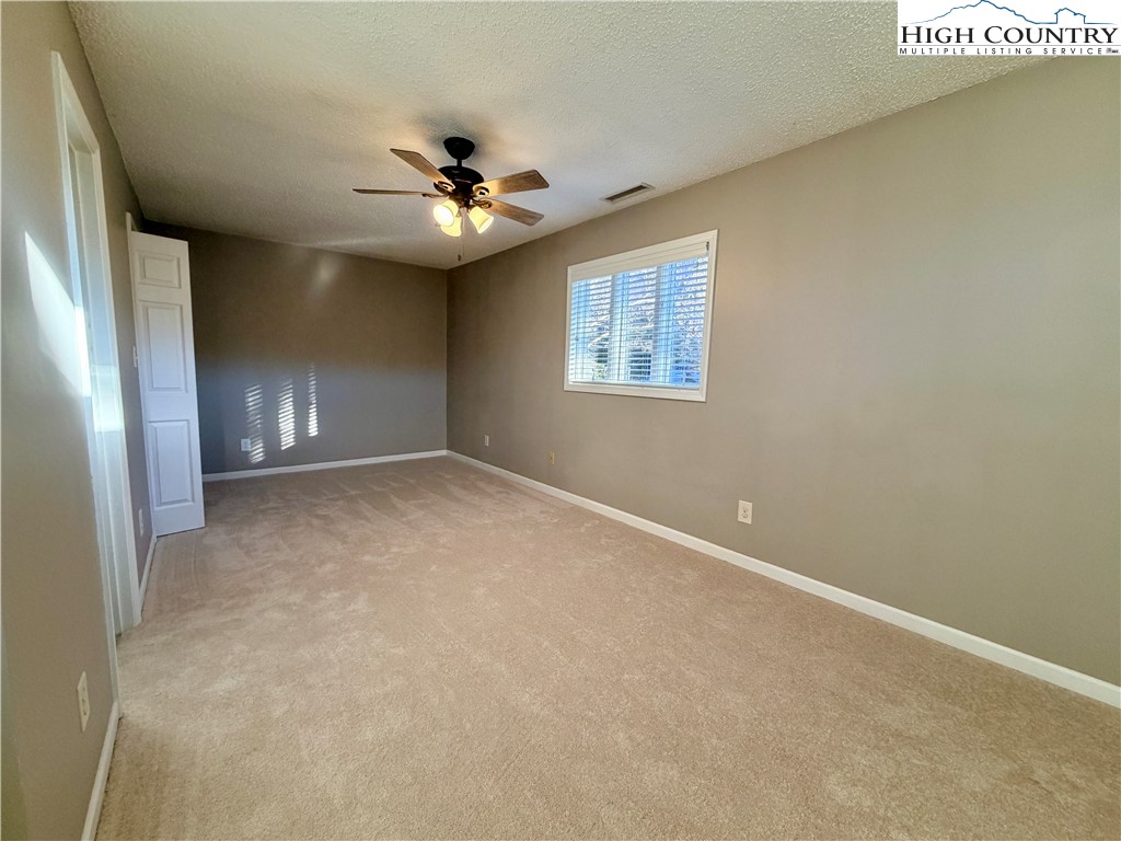 290 Cobble Creek Lane Boone, NC 28607 - Photo 25 of 33 an empty room with windows and fan