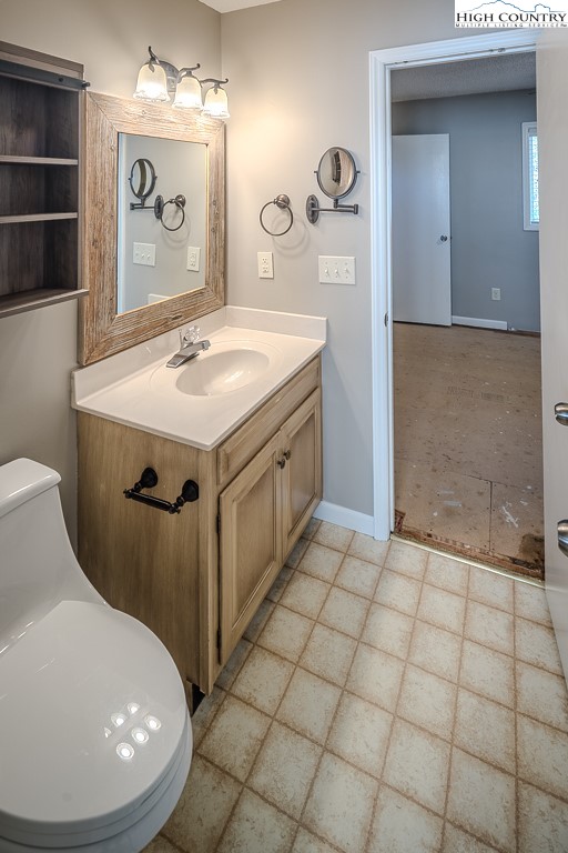 290 Cobble Creek Lane Boone, NC 28607 - Photo 26 of 33 a bathroom with a sink a toilet and mirror