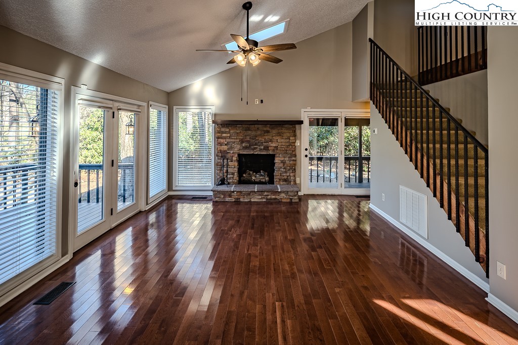 290 Cobble Creek Lane Boone, NC 28607 - Photo 8 of 33 a view of an empty room with wooden floor fireplace and a window