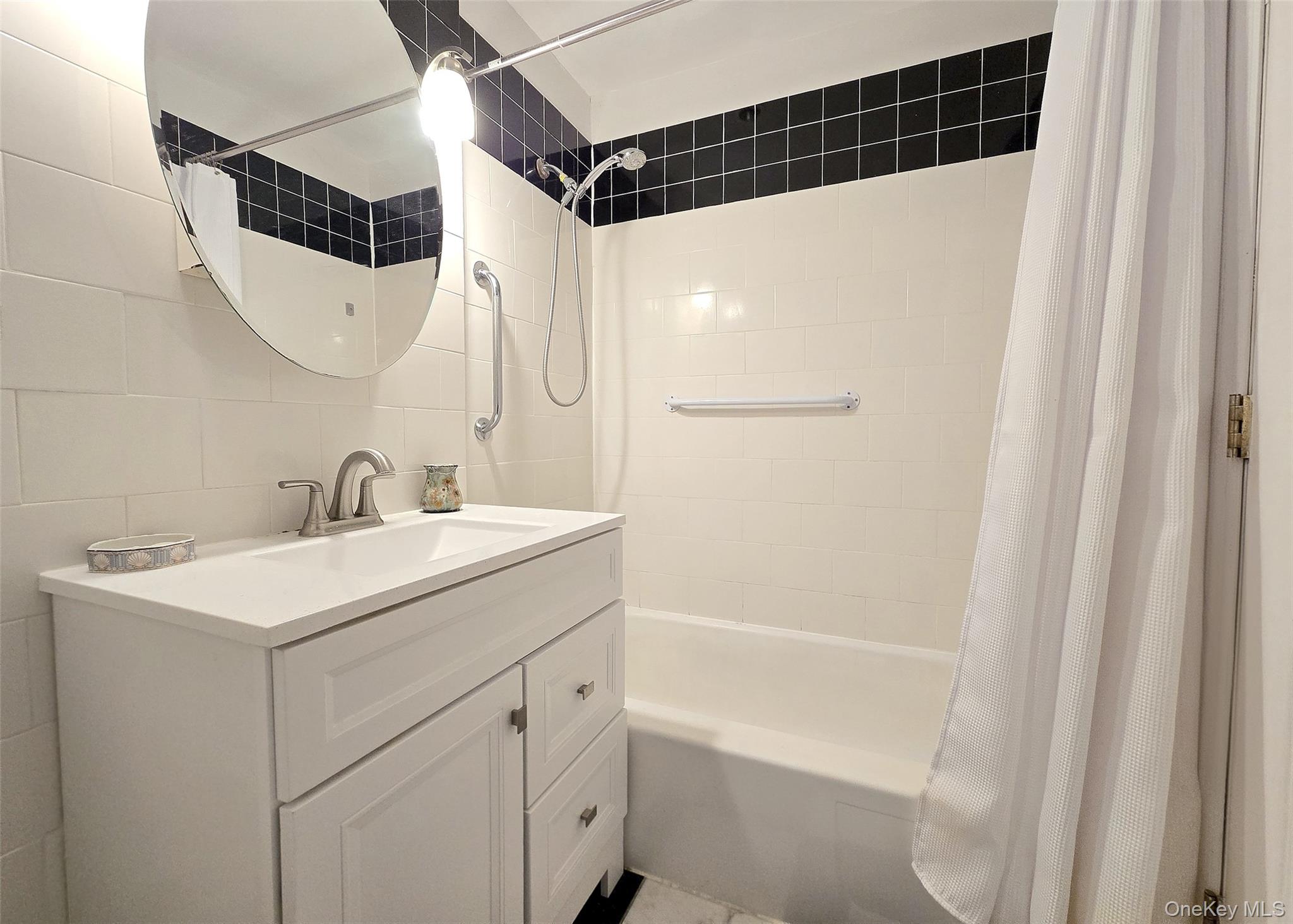 460 Old Town Road, Unit 5B East Setauket, NY 11772 - Photo 11 of 12 a bathroom with a sink and a mirror