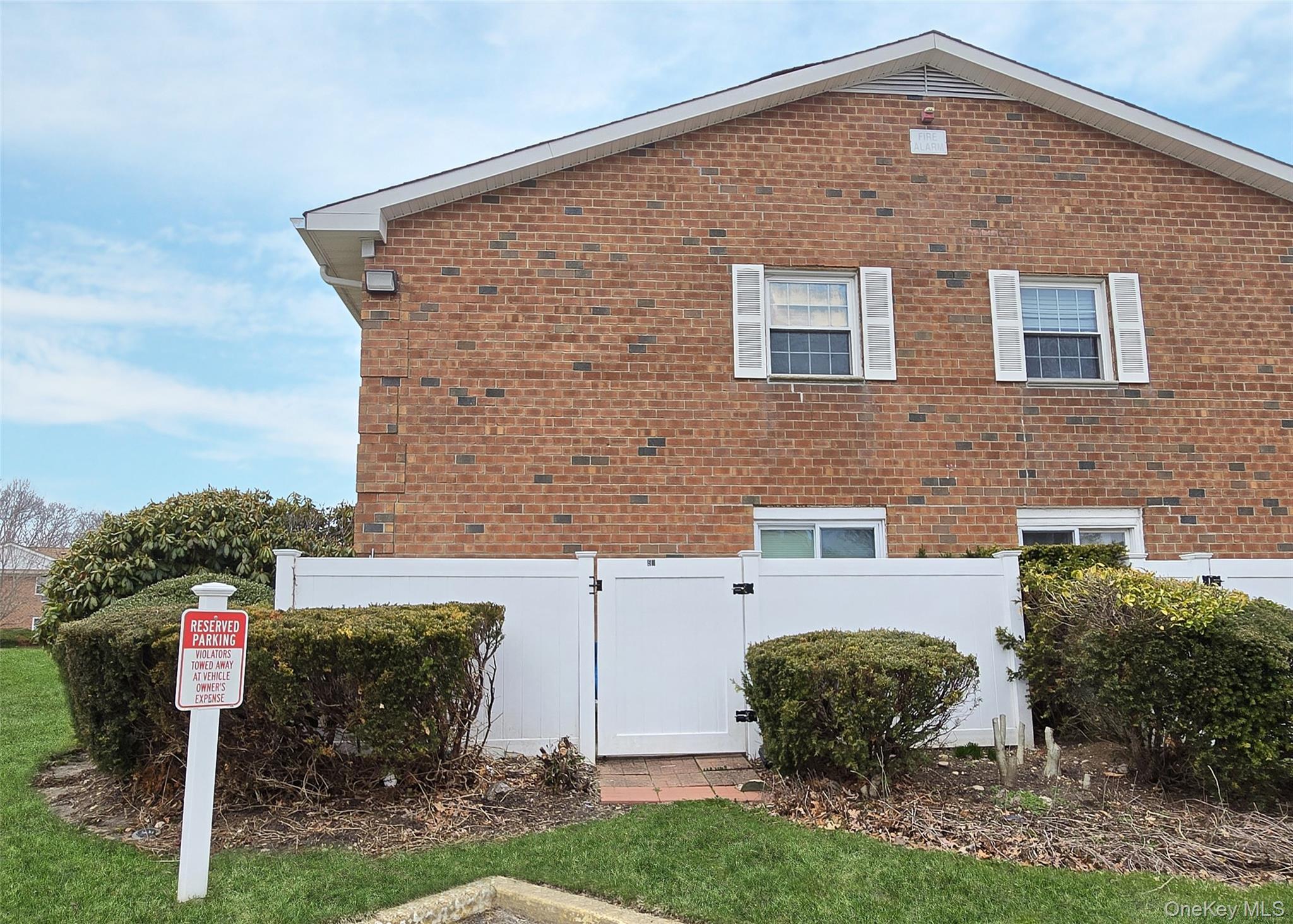 460 Old Town Road, Unit 5B East Setauket, NY 11772 - Photo 12 of 12 a front view of a house with garden
