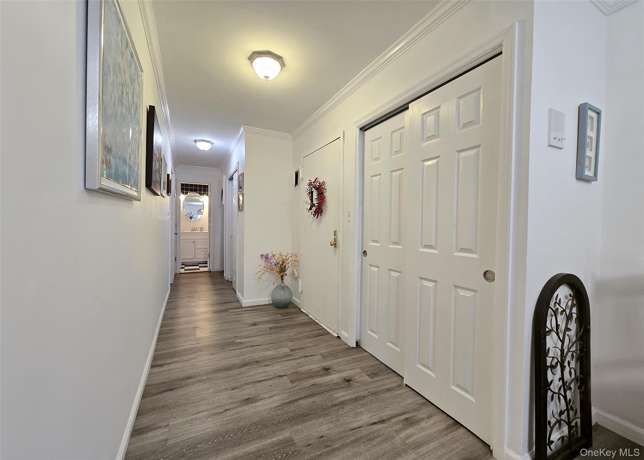 460 Old Town Road, Unit 5B East Setauket, NY 11772 - Photo 2 of 12 a view of a hallway with wooden floor