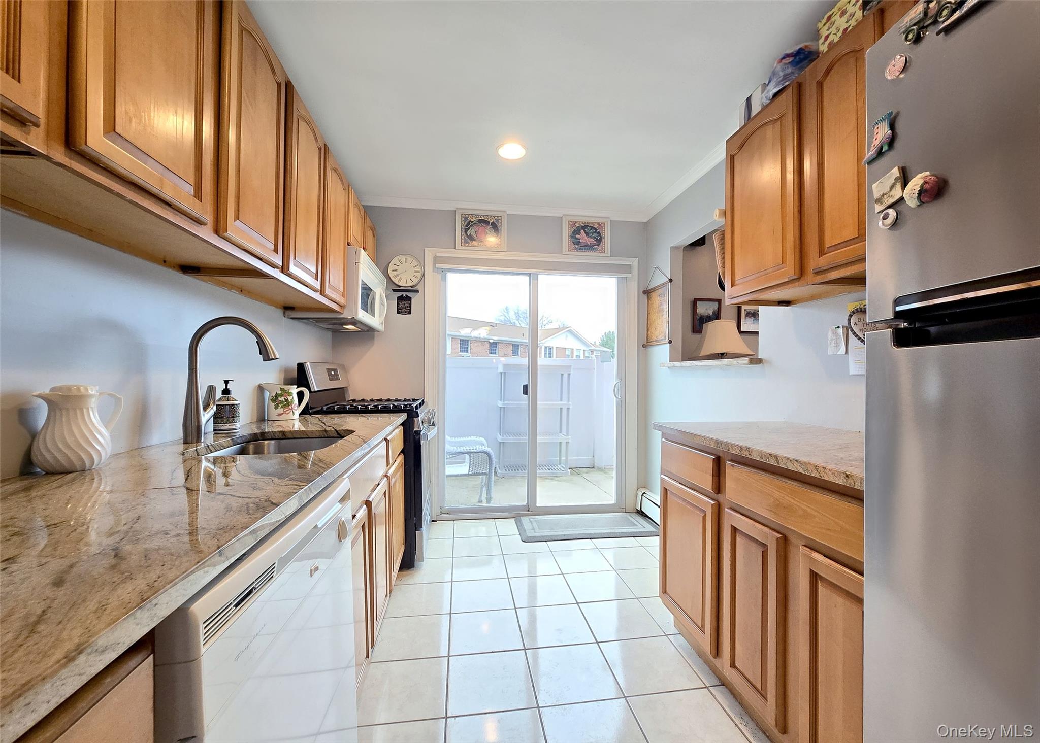 460 Old Town Road, Unit 5B East Setauket, NY 11772 - Photo 5 of 12 a kitchen with stainless steel appliances granite countertop a sink stove and refrigerator