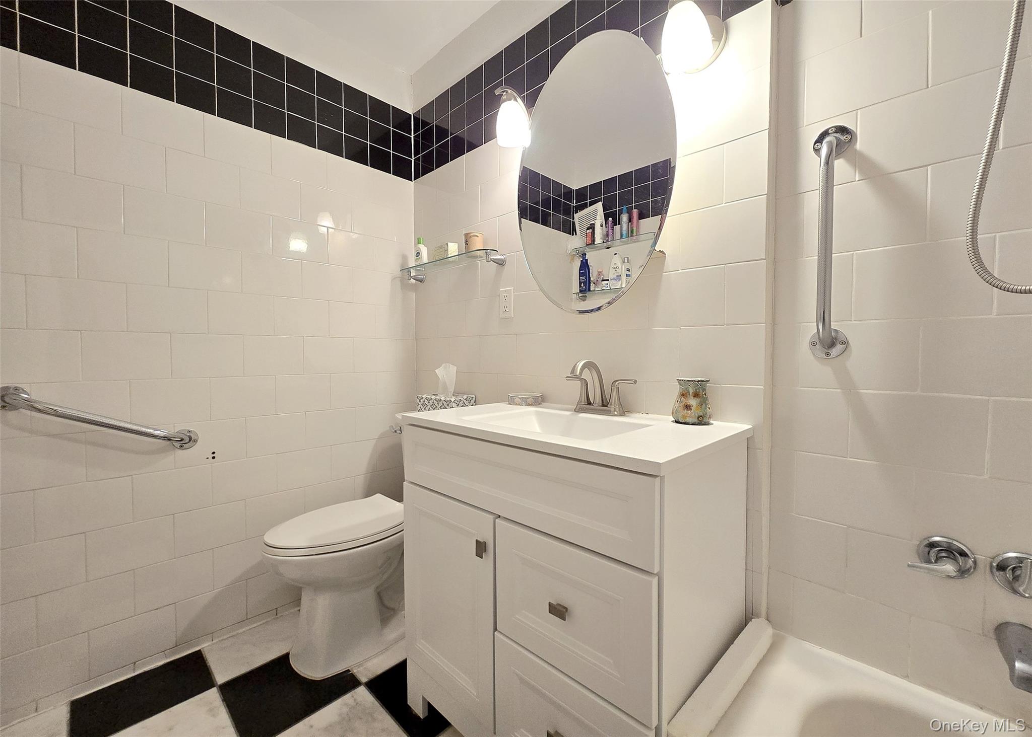 460 Old Town Road, Unit 5B East Setauket, NY 11772 - Photo 10 of 12 a bathroom with a sink toilet and shower