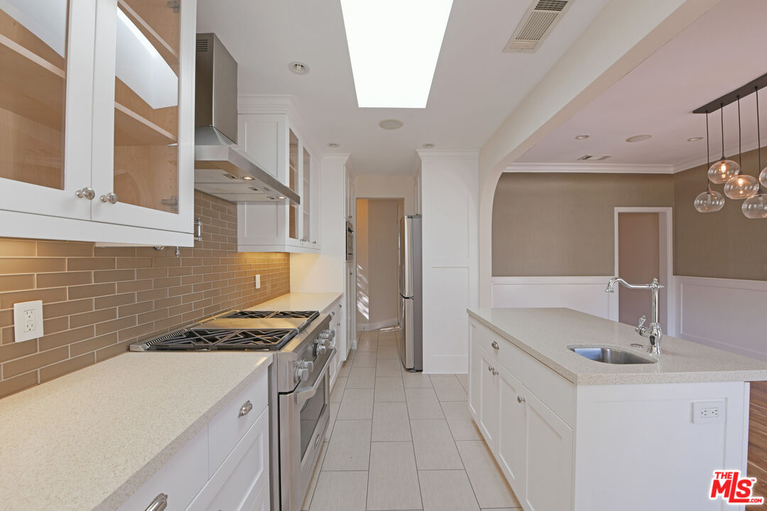 1657 South Point View Street Los Angeles, CA 90035 - Photo 12 of 50 a kitchen that has a sink and a stove