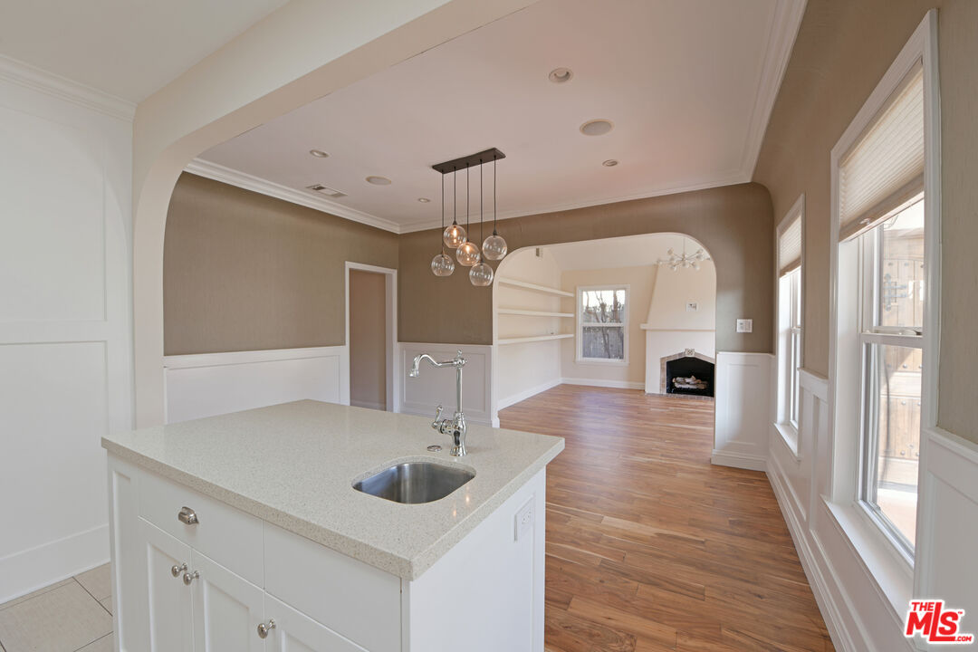 1657 South Point View Street Los Angeles, CA 90035 - Photo 13 of 50 a view of a hallway with wooden floor windows and a chandelier