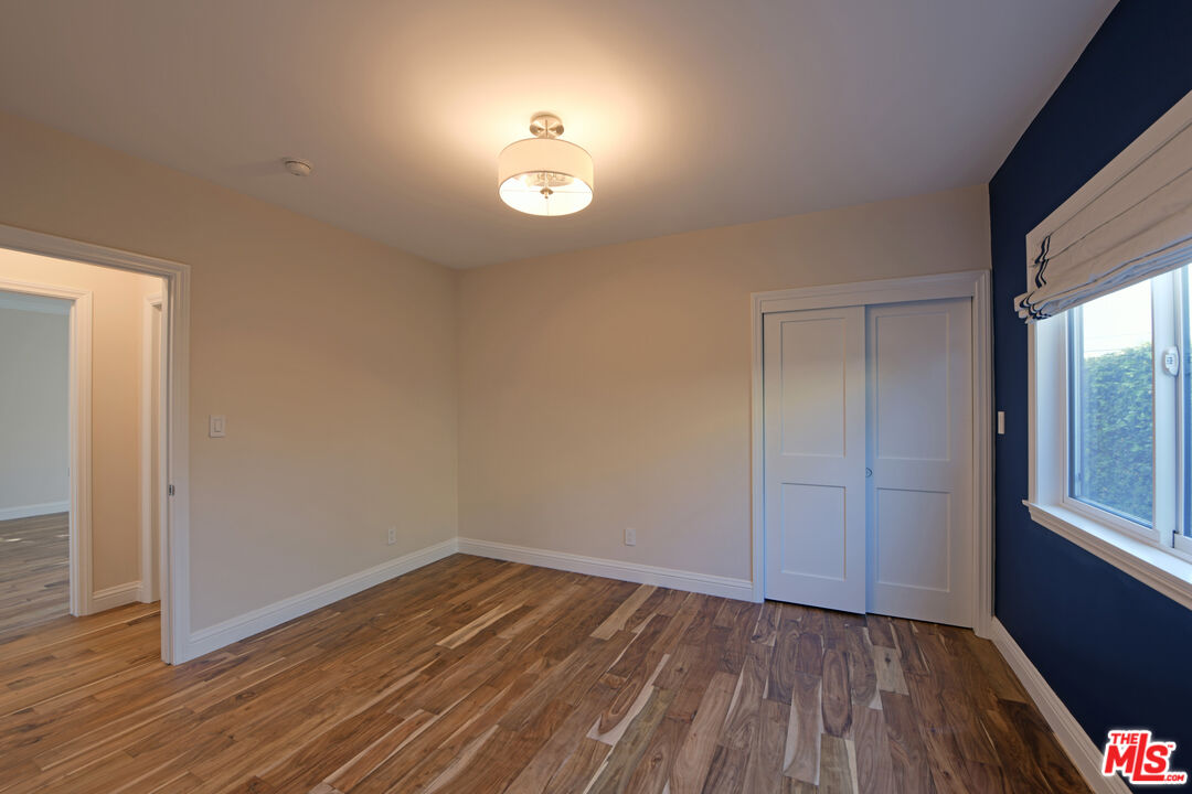 1657 South Point View Street Los Angeles, CA 90035 - Photo 20 of 50 an empty room with wooden floor and windows