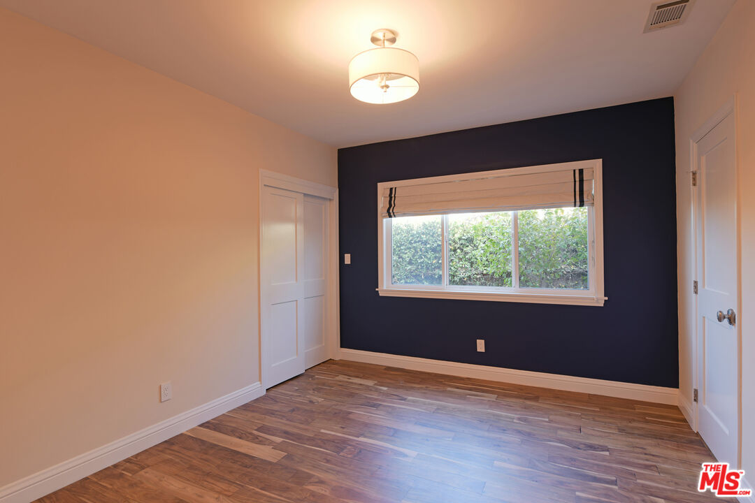 1657 South Point View Street Los Angeles, CA 90035 - Photo 24 of 50 wooden floor in an empty room with a window