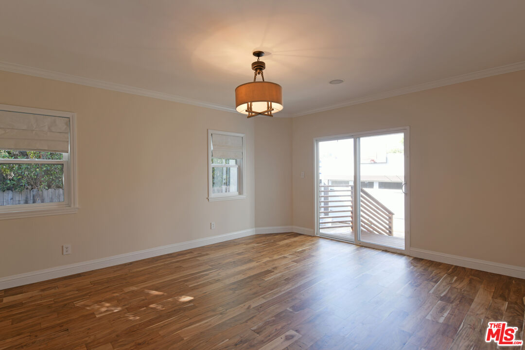 1657 South Point View Street Los Angeles, CA 90035 - Photo 25 of 50 a view of an empty room with wooden floor and a window