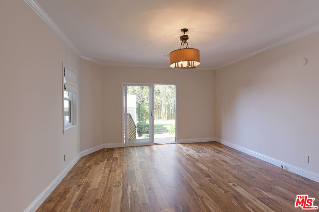 1657 South Point View Street Los Angeles, CA 90035 - Photo 27 of 50 a view of an empty room with wooden floor and a window