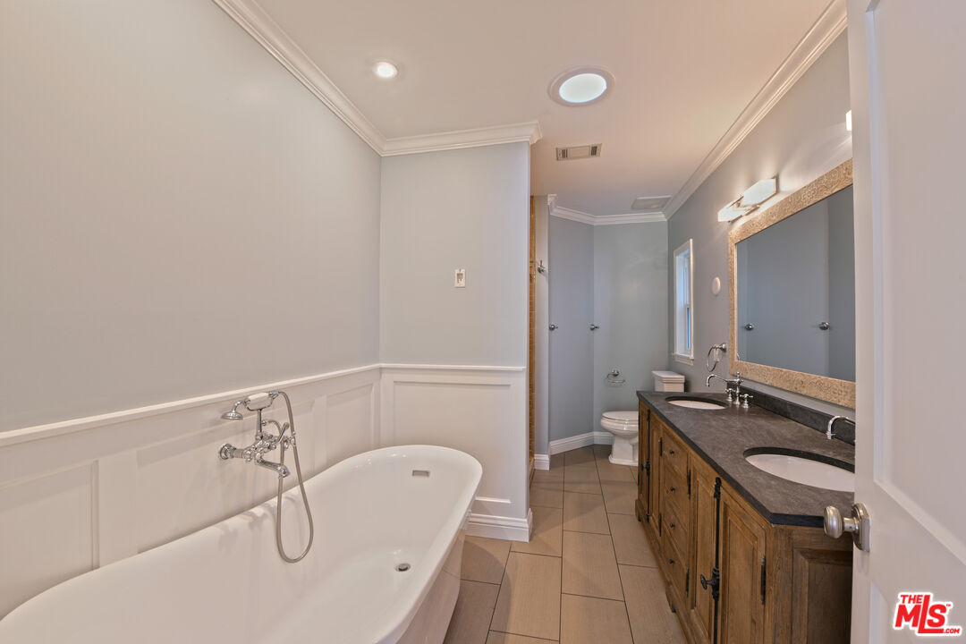 1657 South Point View Street Los Angeles, CA 90035 - Photo 31 of 50 a bathroom with a tub sink and mirror