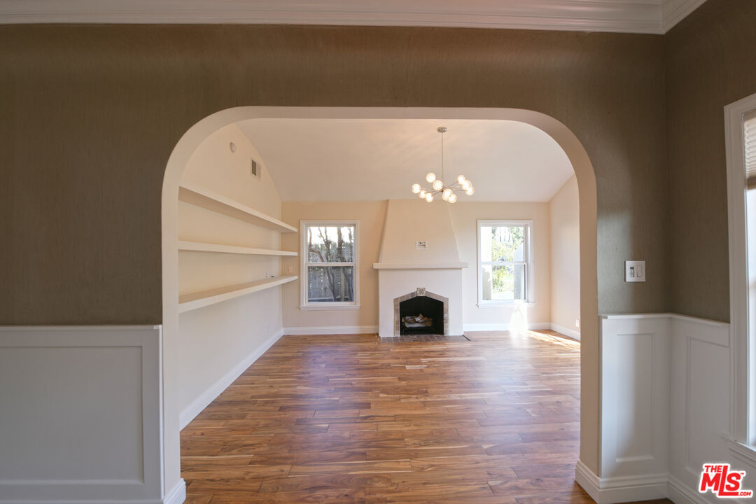 1657 South Point View Street Los Angeles, CA 90035 - Photo 37 of 50 a view of a livingroom with a fireplace wooden floor and windows