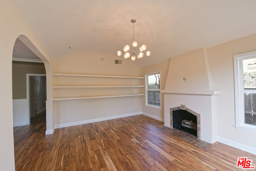 1657 South Point View Street Los Angeles, CA 90035 - Photo 38 of 50 a view of a livingroom with wooden floor a fireplace and a window