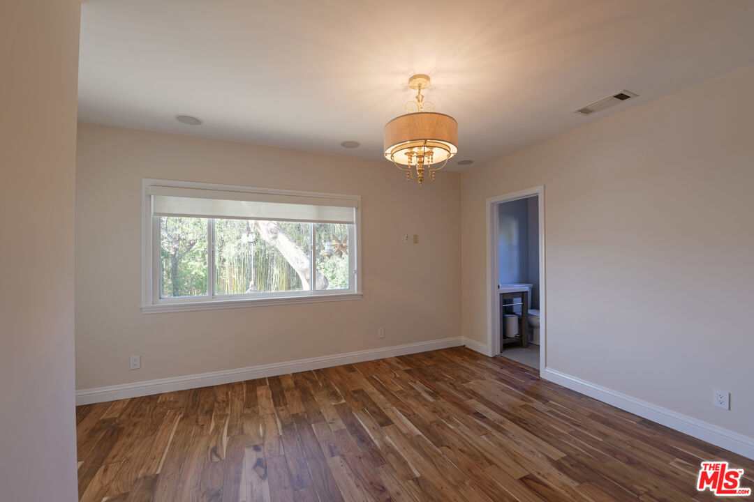 1657 South Point View Street Los Angeles, CA 90035 - Photo 5 of 50 an empty room with wooden floor and window