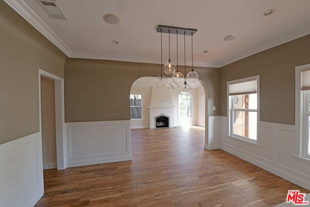 1657 South Point View Street Los Angeles, CA 90035 - Photo 10 of 50 a view of an empty room with wooden floor and a window