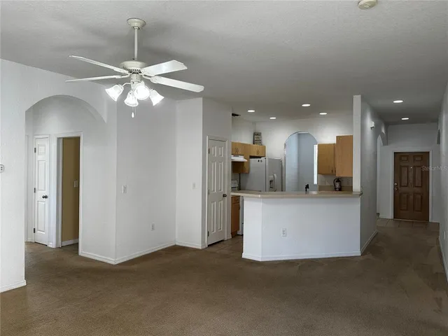 a view of a kitchen with a refrigerator and a chandelier