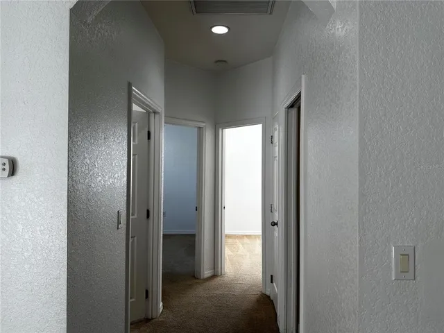 a view of a hallway with a bathroom