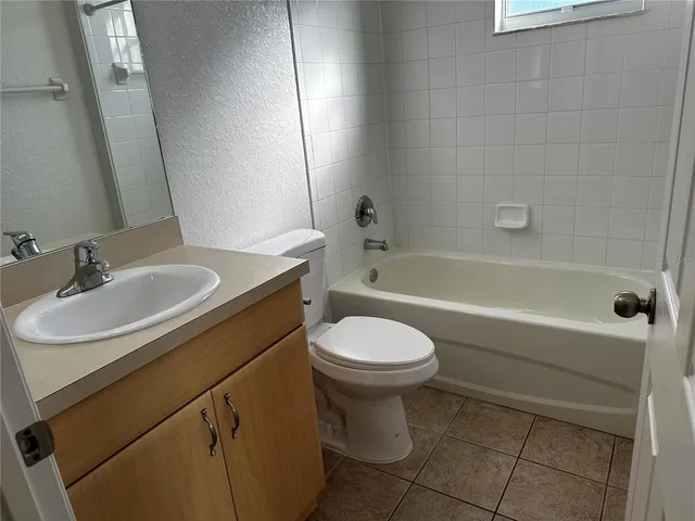 a bathroom with a sink toilet vanity and bathtub