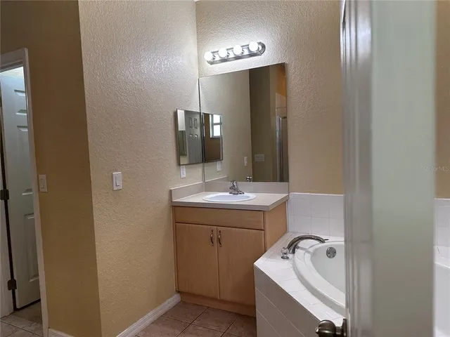 a bathroom with a sink and mirror