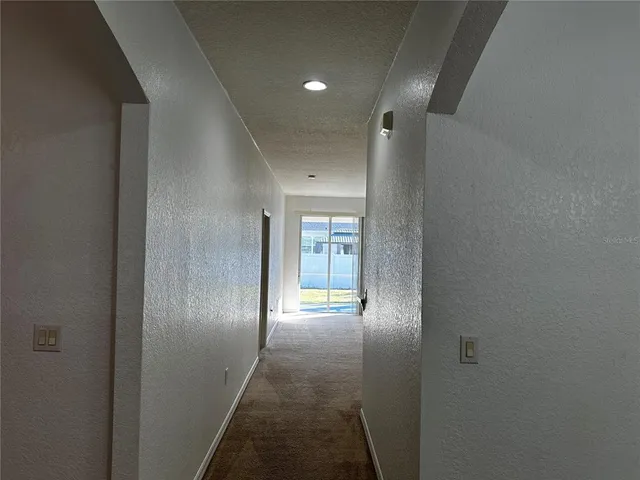a view of hallway with wooden floor