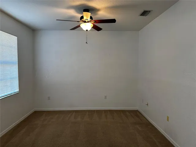 a view of a room with a fan and a window