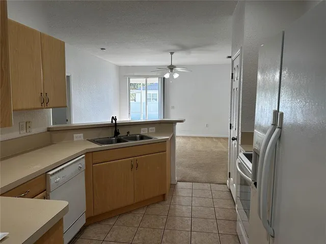 a kitchen with a sink and a refrigerator