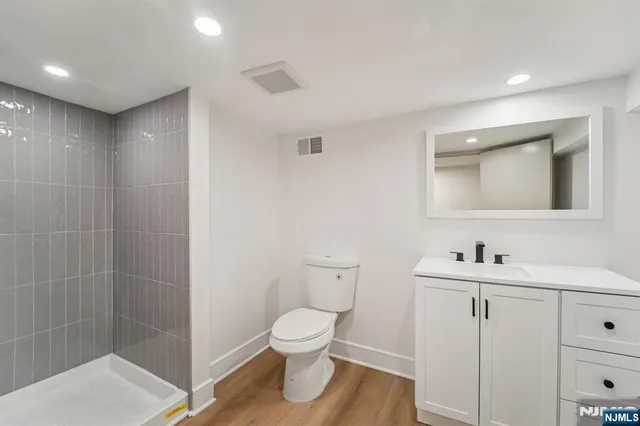 a bathroom with a toilet sink and mirror