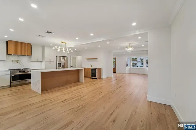 a view of kitchen with cabinets stainless steel appliances with wooden floor