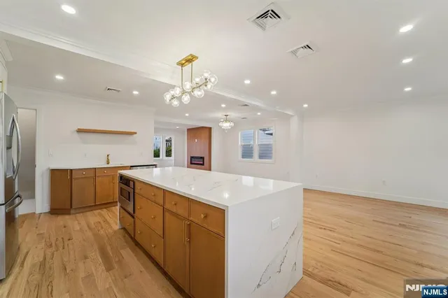 a kitchen with a sink a counter top space and stainless steel appliances