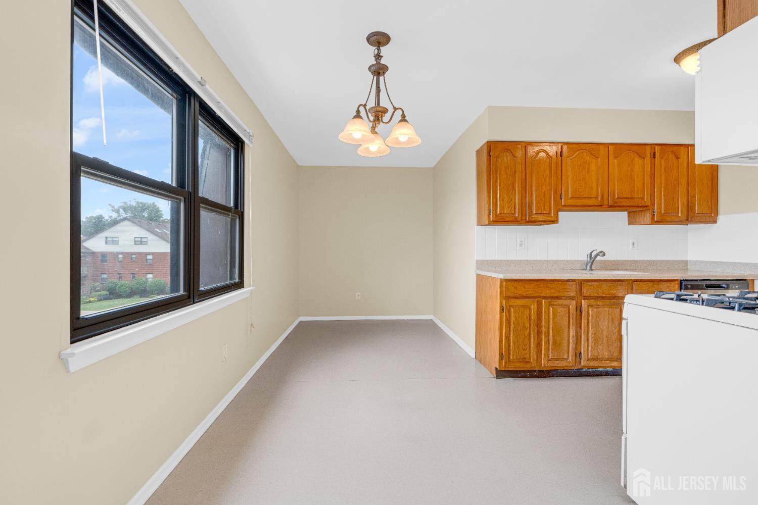 101 Beverly Hl Terrace, Unit M Woodbridge, NJ 07095 - Photo 15 of 28 a view of a kitchen with a sink cabinet and a window