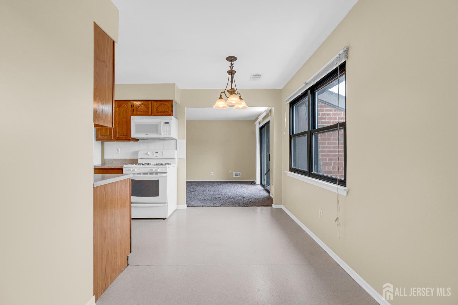101 Beverly Hl Terrace, Unit M Woodbridge, NJ 07095 - Photo 16 of 28 a kitchen with furniture and window