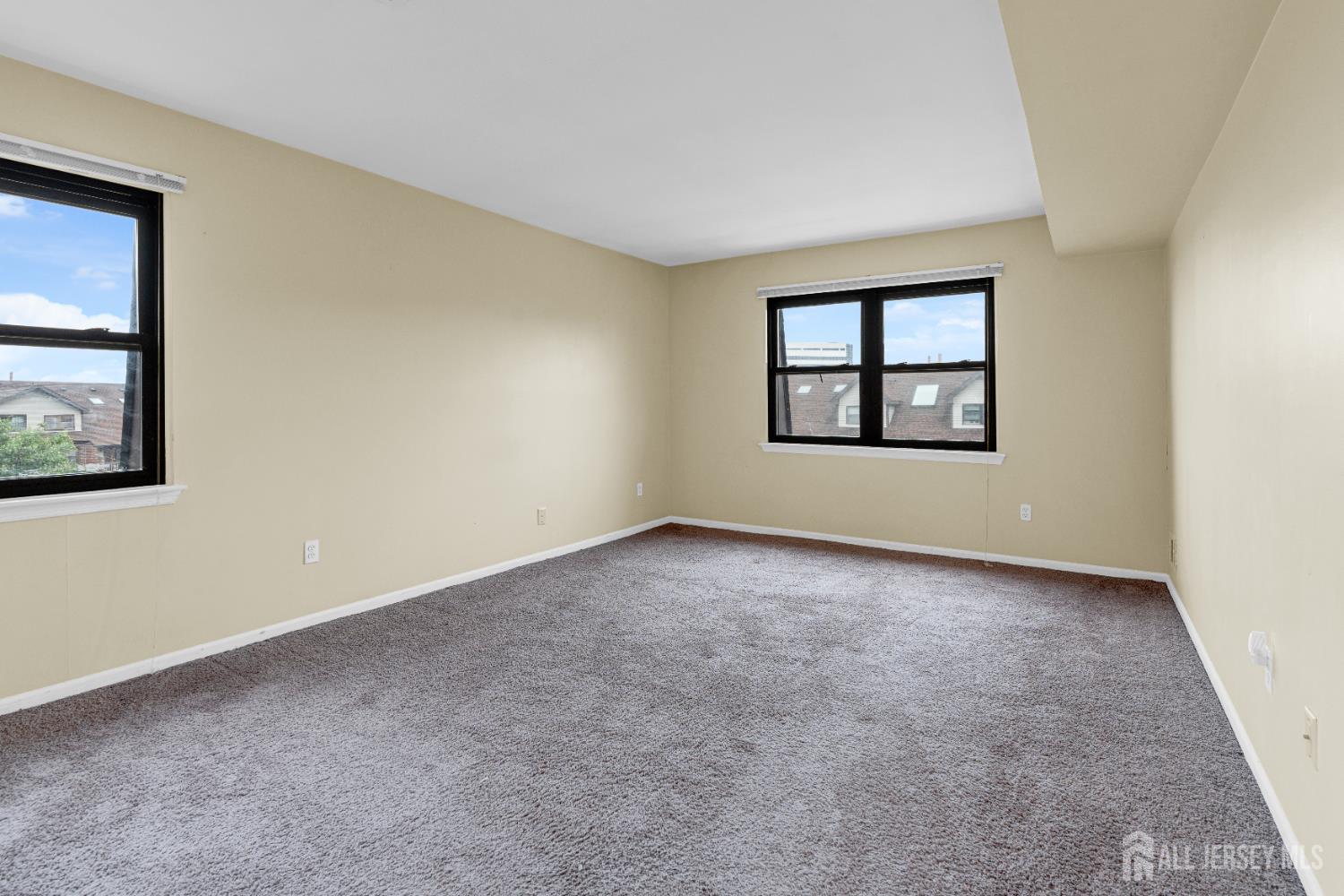 101 Beverly Hl Terrace, Unit M Woodbridge, NJ 07095 - Photo 19 of 28 an empty room with windows and closet