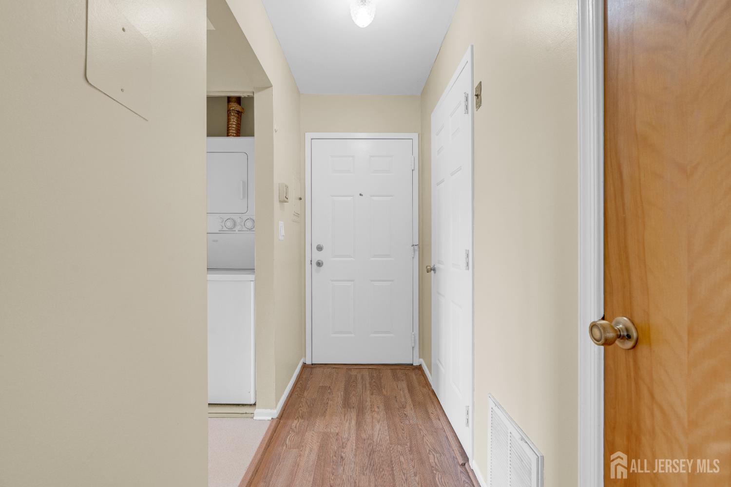 101 Beverly Hl Terrace, Unit M Woodbridge, NJ 07095 - Photo 5 of 28 a view of a hallway with wooden floor