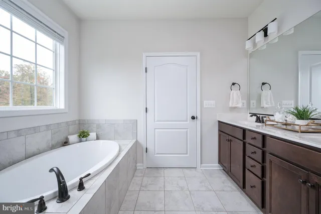 a kitchen with a dining table chairs and wooden floor