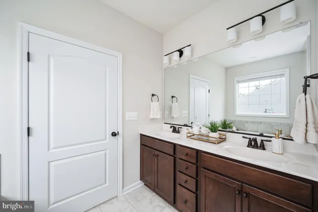 a kitchen with kitchen island stainless steel appliances a sink stove and refrigerator