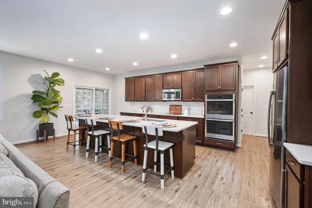 a kitchen with a sink appliances and cabinets