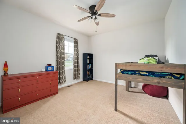 a view of a bedroom with cabinet and windows