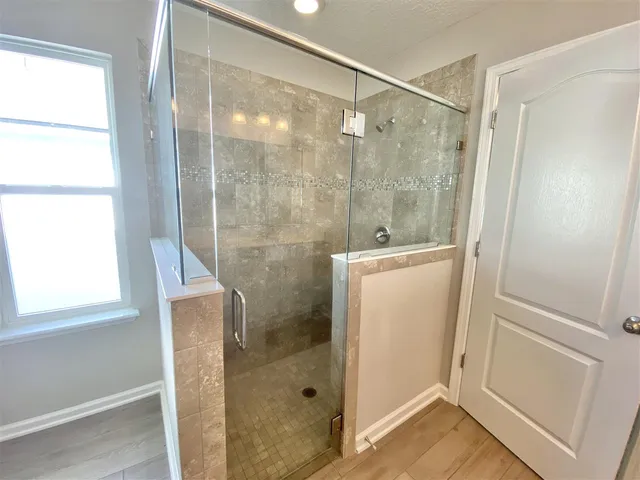 a bathroom with a shower and a sink