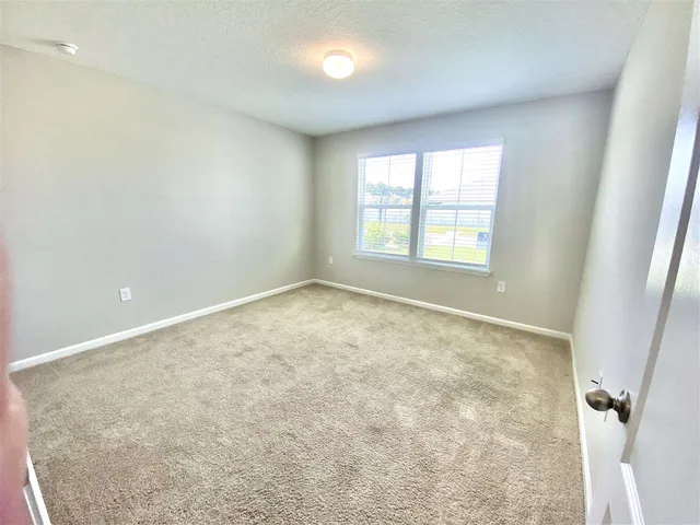 an empty room with a empty space and windows