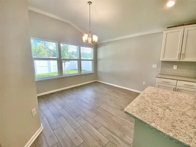 a view of kitchen and hall with wooden floor