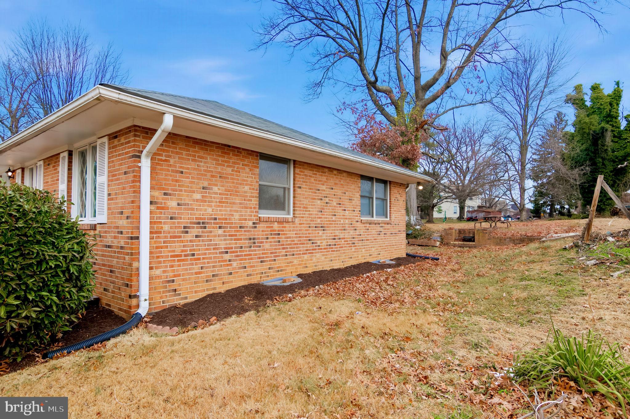3723 Munson Road Falls Church, VA 22041 - Photo 14 of 30 a backyard of a house with large trees and covered by wooden fence