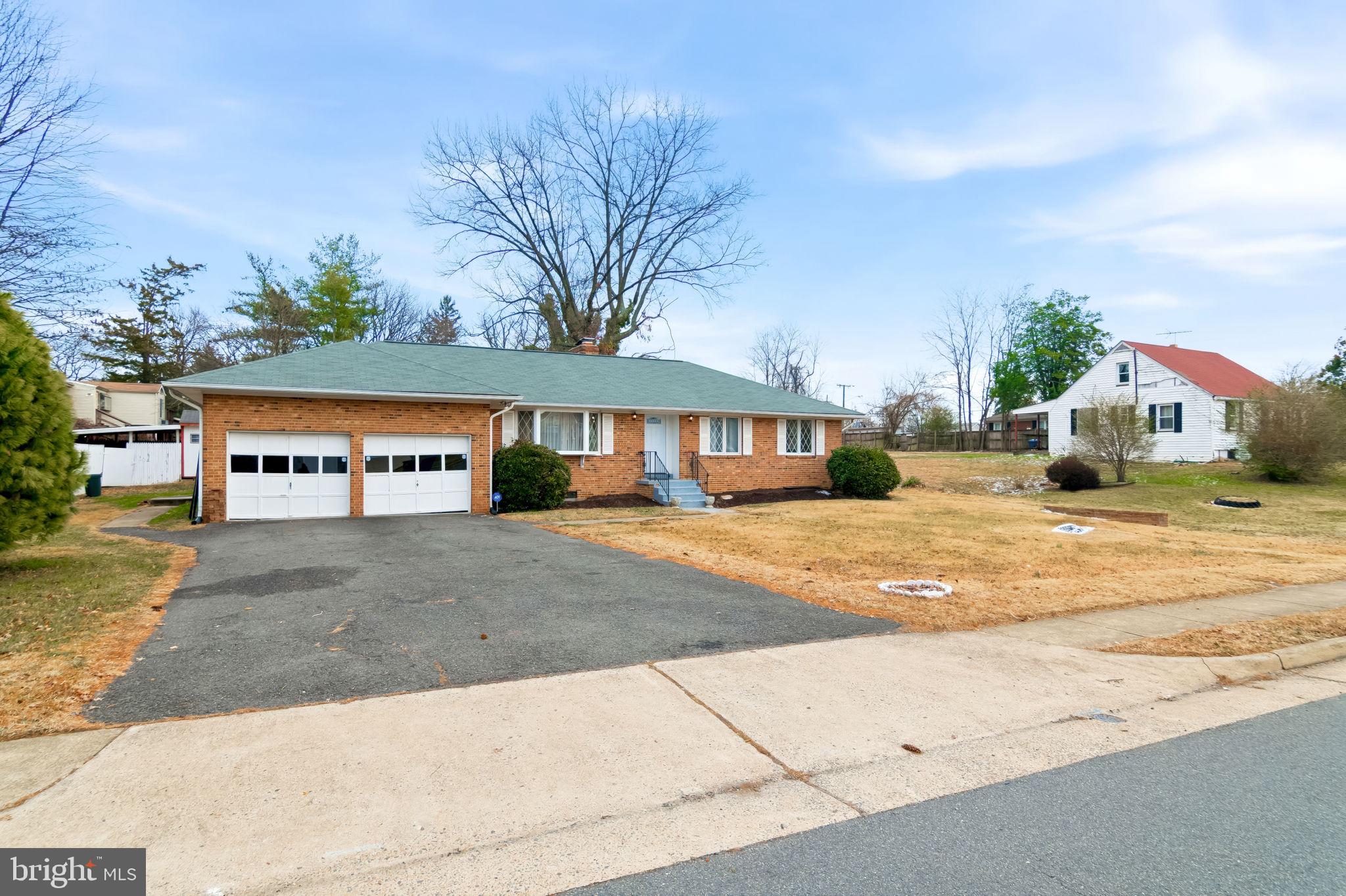 3723 Munson Road Falls Church, VA 22041 - Photo 15 of 30 a front view of a building with large trees and entryway