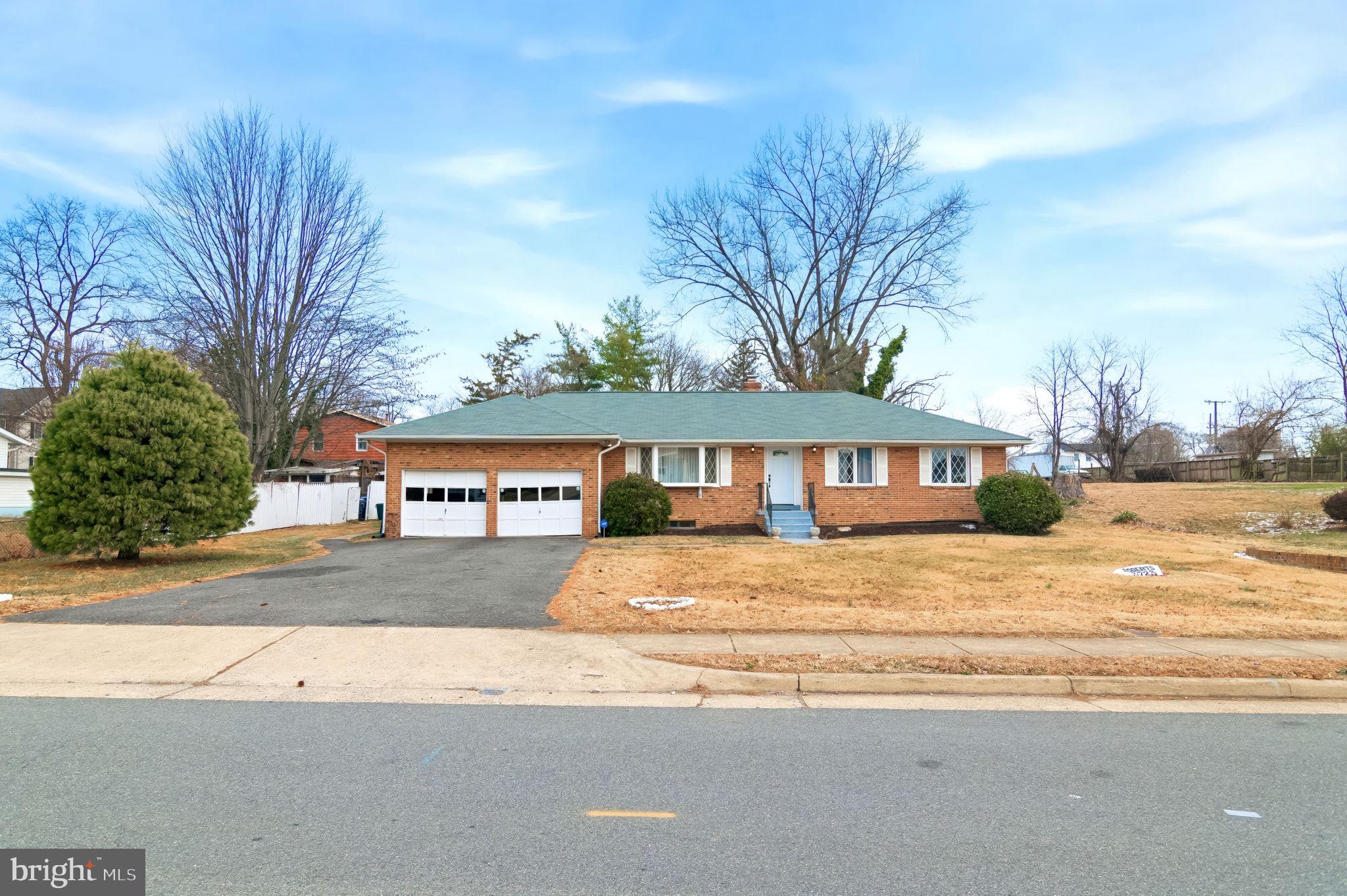 3723 Munson Road Falls Church, VA 22041 - Photo 17 of 30 a front view of a house with a yard and garage