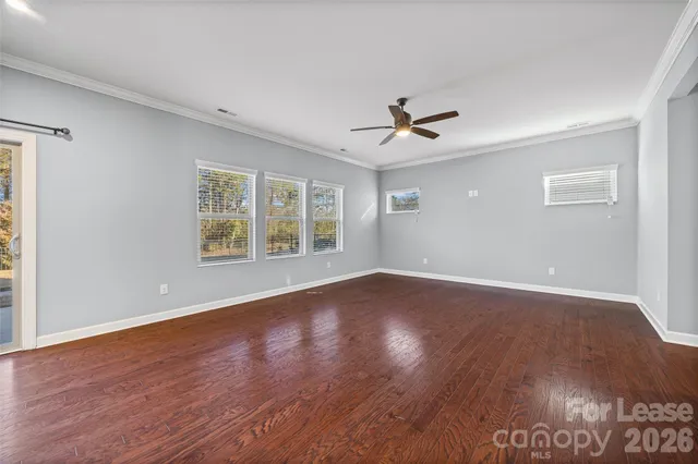 a view of a kitchen with wooden floor and a kitchen